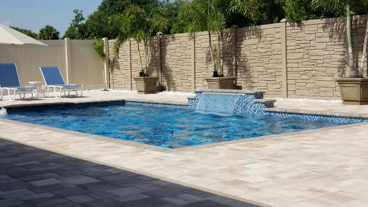 Piscine enterrée haut de gamme avec plage en pierre et lame d’eau